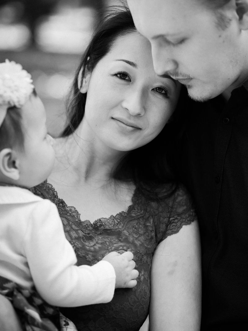 Black and white portrait of a couple holding their baby