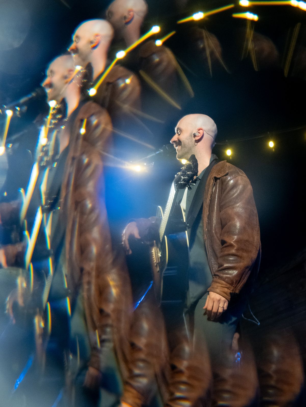A frontman at the microphone, multiplied through a prism