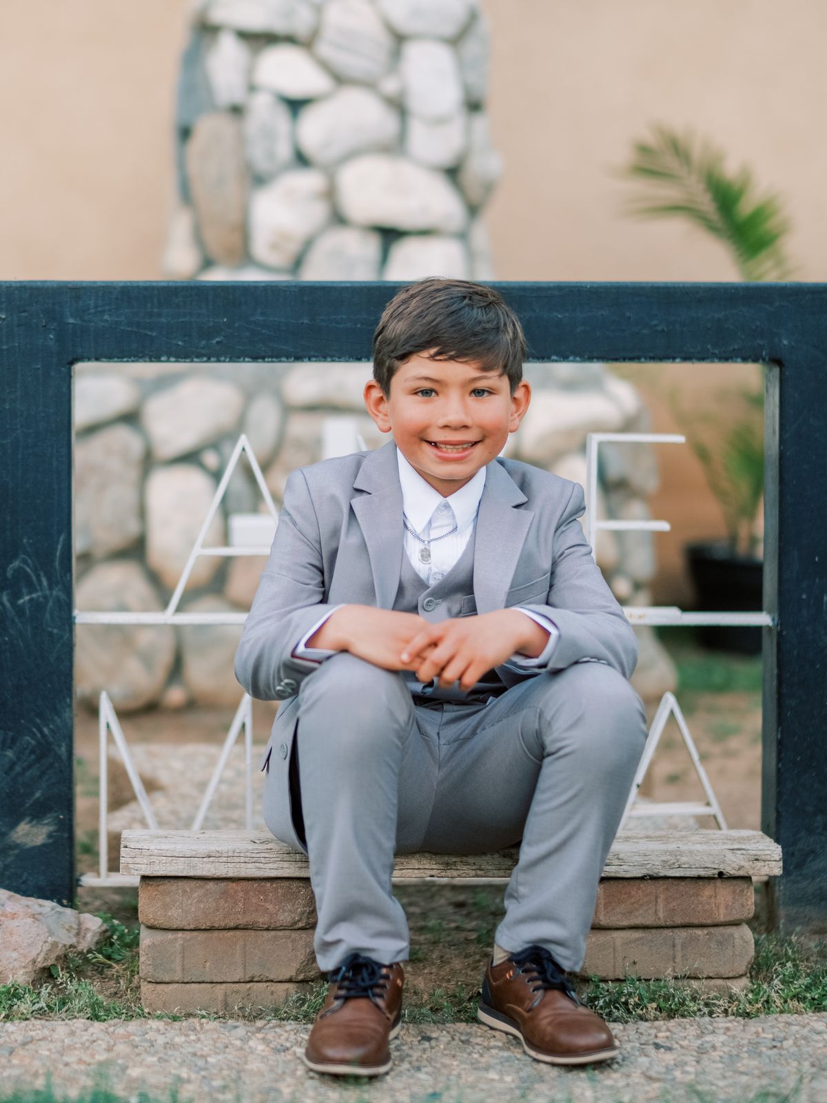 A boy in a gray suit on his First Communion day